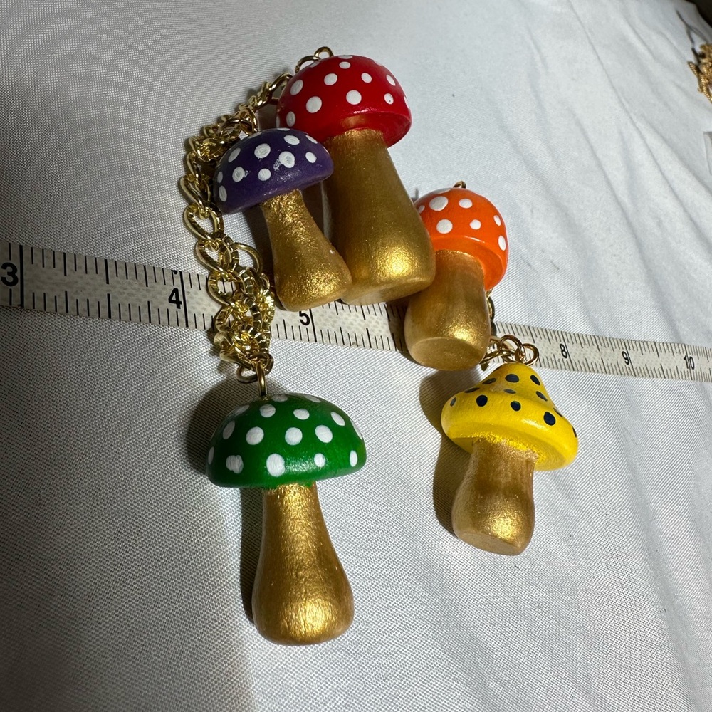 Dangling mushrooms on goldtone bracelet